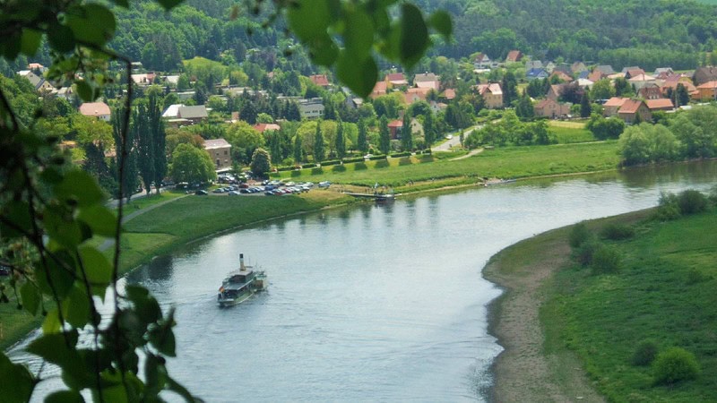 Ein Dampfer fährt auf der Elbe entlang.