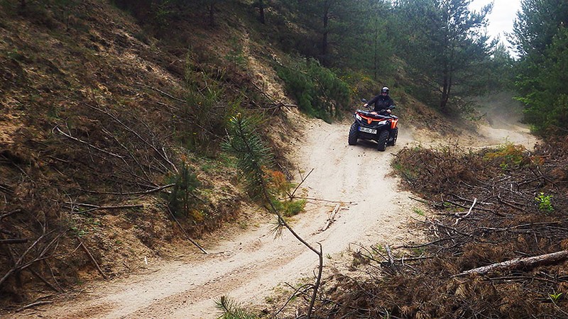 Ein Mann fährt bei der Quad Tour in der Oberlausitz auf einem Waldweg.